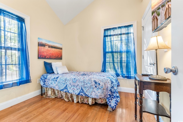 bedroom with hardwood / wood-style floors and vaulted ceiling