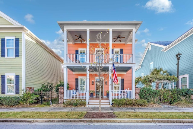 view of front of house featuring a porch, ceiling fan, and a balcony