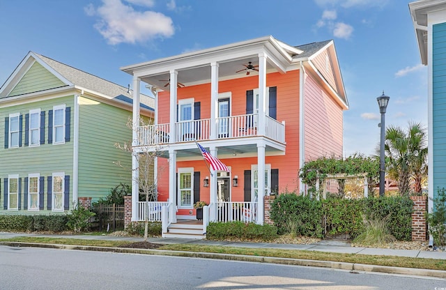 view of front of property with a balcony, ceiling fan, and covered porch