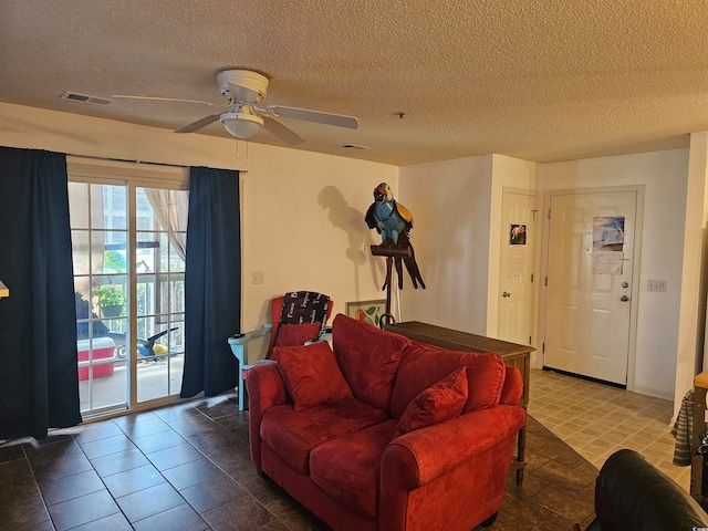 tiled living room with a textured ceiling and ceiling fan