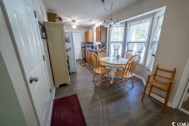 dining room featuring hardwood / wood-style floors and ceiling fan with notable chandelier