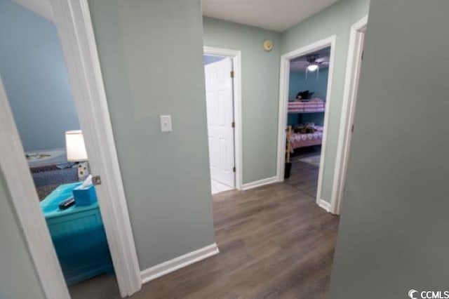 corridor with hardwood / wood-style flooring