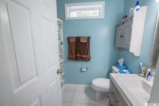 bathroom featuring toilet, vanity, and tile patterned floors