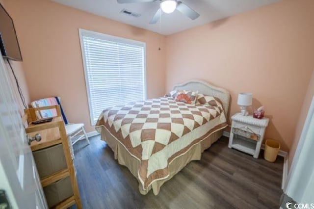 bedroom with ceiling fan and dark hardwood / wood-style floors