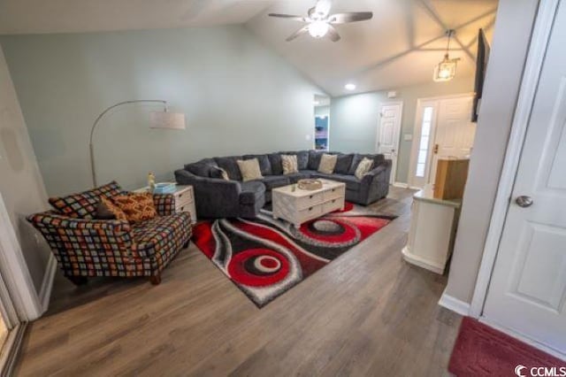 living room with hardwood / wood-style flooring, ceiling fan, and vaulted ceiling