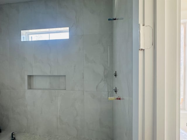 full bathroom with tiled shower