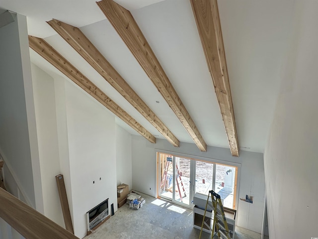 unfurnished living room with beam ceiling