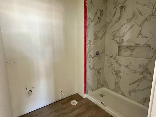 bathroom featuring walk in shower and wood finished floors