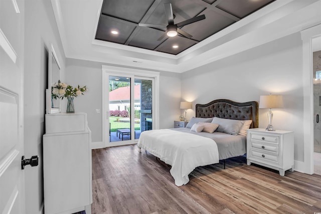 bedroom with access to exterior, baseboards, coffered ceiling, and wood finished floors