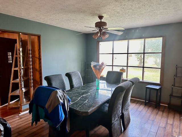 dining room featuring ceiling fan, wood-type flooring, and a textured ceiling