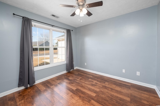 unfurnished room with a textured ceiling, dark hardwood / wood-style floors, and ceiling fan