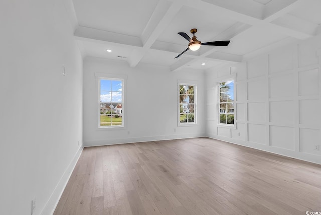 spare room with ceiling fan, beamed ceiling, a healthy amount of sunlight, and coffered ceiling