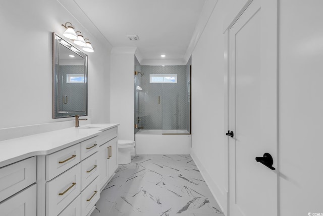 full bathroom featuring vanity, toilet, enclosed tub / shower combo, and crown molding