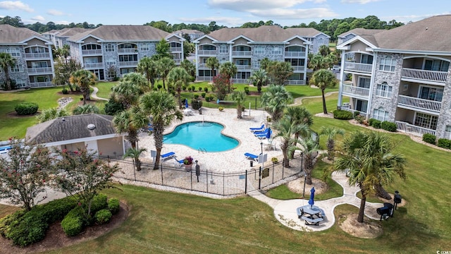 view of pool featuring a lawn and a patio