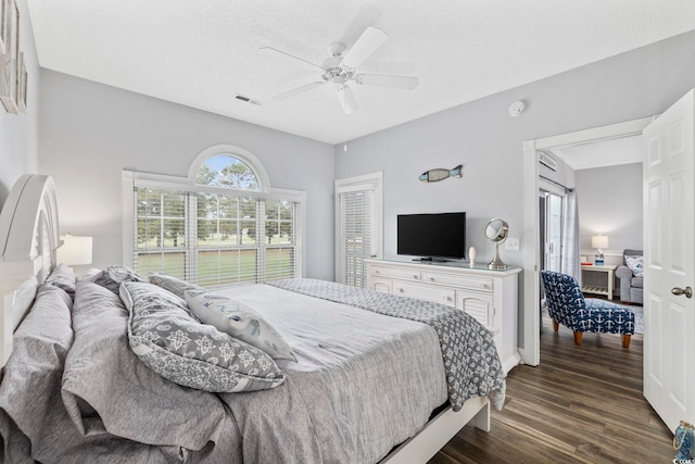 bedroom with ceiling fan and dark hardwood / wood-style floors