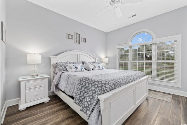 bedroom featuring ceiling fan and dark hardwood / wood-style floors