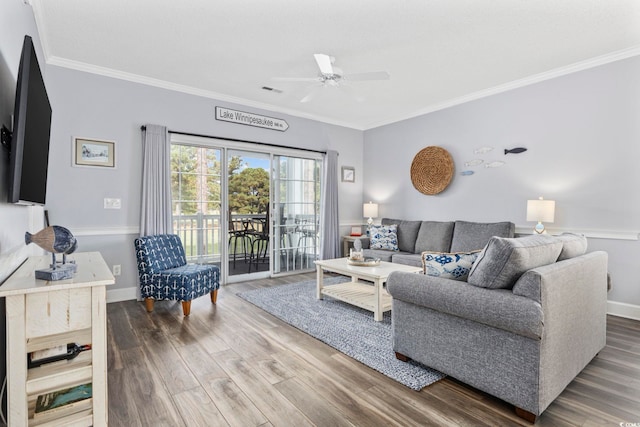 living room with hardwood / wood-style floors, ceiling fan, and ornamental molding