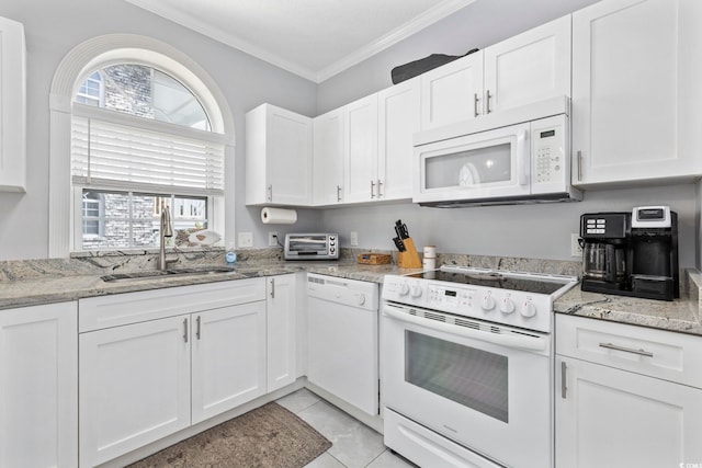 kitchen featuring sink, ornamental molding, light tile patterned flooring, white cabinetry, and white appliances