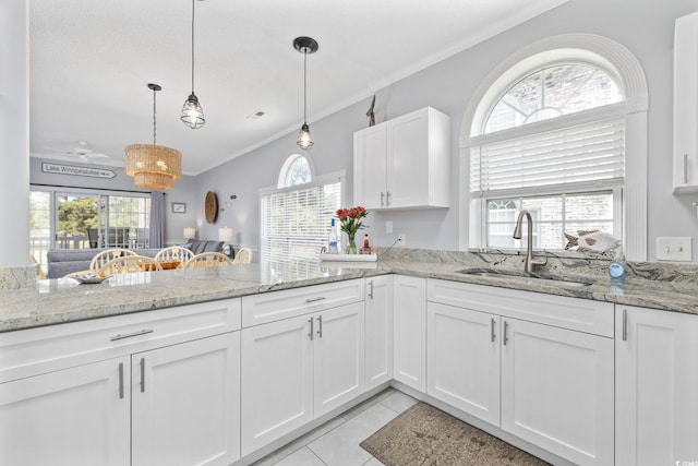 kitchen featuring plenty of natural light and white cabinetry