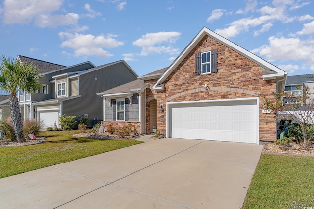 traditional-style home with stone siding, driveway, a front yard, and a garage