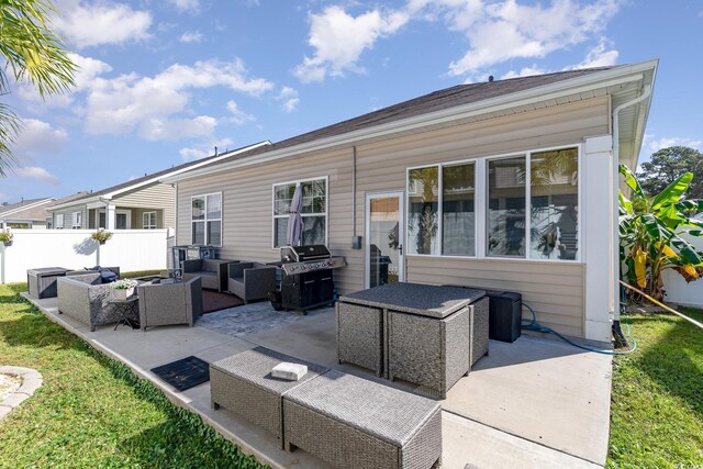 back of house with an outdoor living space and a patio area