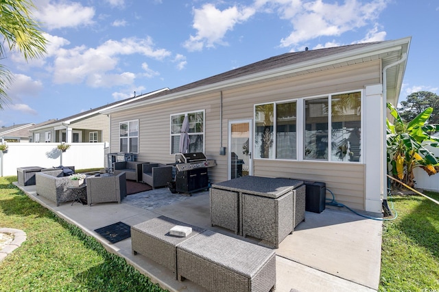 rear view of property featuring an outdoor living space, a yard, a patio area, and fence