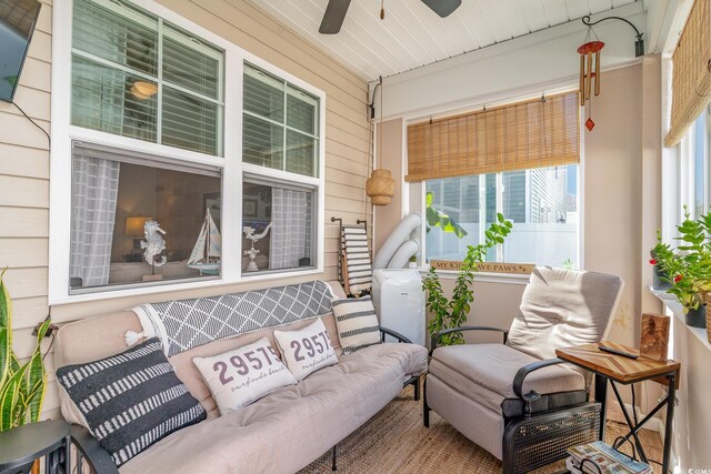 sunroom / solarium with ceiling fan and a healthy amount of sunlight