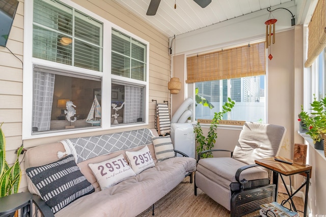 sunroom / solarium with a ceiling fan