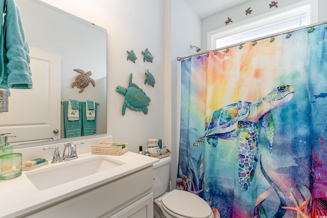 bathroom featuring vanity, a shower with shower curtain, and toilet