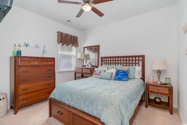 bedroom featuring light colored carpet, visible vents, and ceiling fan