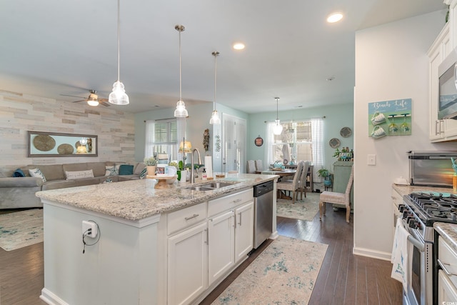 kitchen with white cabinets, a wealth of natural light, and sink