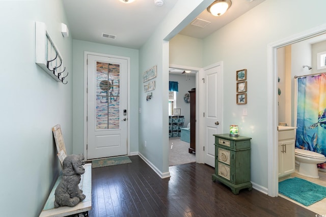 entrance foyer featuring visible vents, dark wood-type flooring, and baseboards