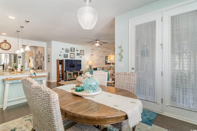 dining area with recessed lighting, dark wood-type flooring, and ceiling fan with notable chandelier