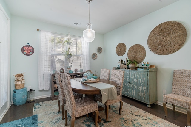 dining space with visible vents, baseboards, and wood finished floors