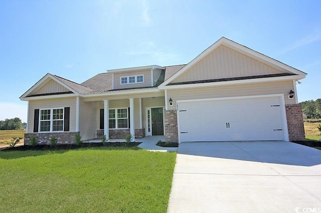 craftsman house featuring a garage and a front lawn