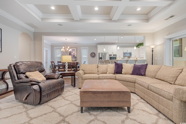 living room with coffered ceiling, a chandelier, ornamental molding, and beam ceiling