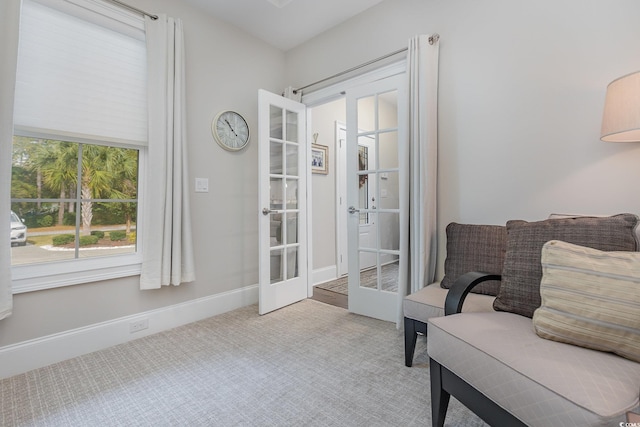 sitting room with light colored carpet and french doors