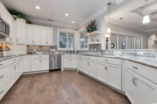 kitchen featuring white cabinets, decorative light fixtures, and stainless steel appliances