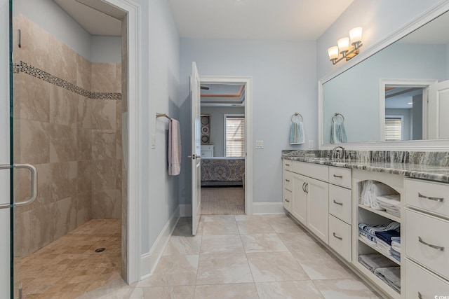 bathroom featuring vanity and tiled shower