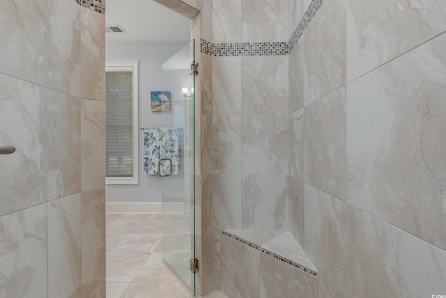 bathroom with tiled shower