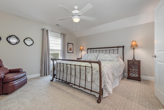 carpeted bedroom with ceiling fan and vaulted ceiling