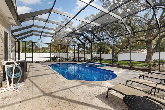 view of swimming pool with a patio, a lanai, and an in ground hot tub