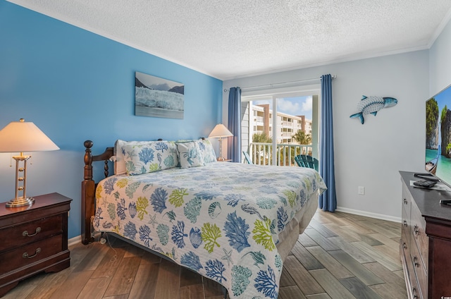 bedroom with wood-type flooring, access to exterior, and a textured ceiling