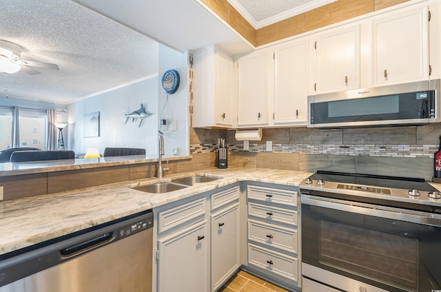 kitchen featuring stainless steel appliances, white cabinetry, sink, and ornamental molding