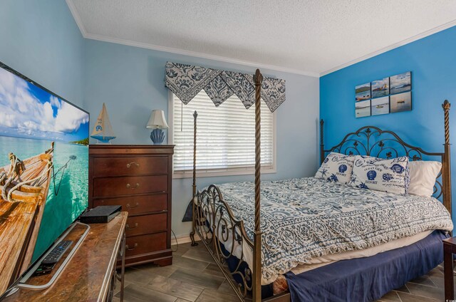 bedroom featuring crown molding and a textured ceiling