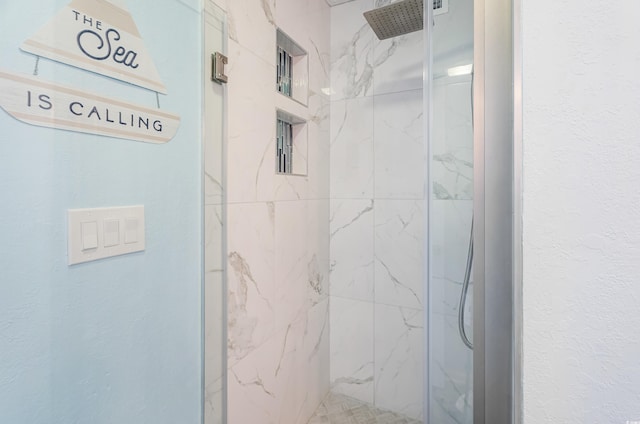 bathroom with a tile shower