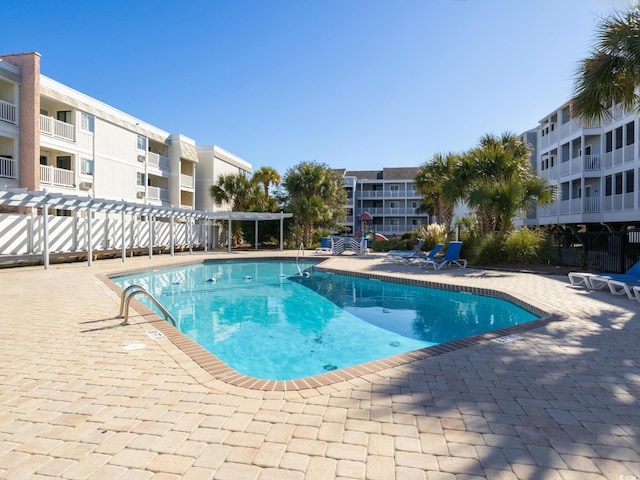 view of pool with a pergola and a patio