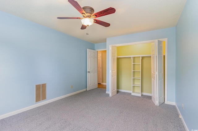 unfurnished bedroom with ceiling fan, a closet, and carpet