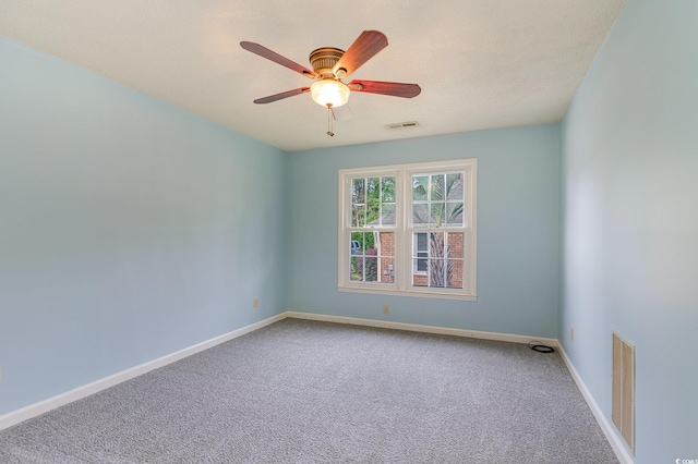 carpeted empty room featuring ceiling fan