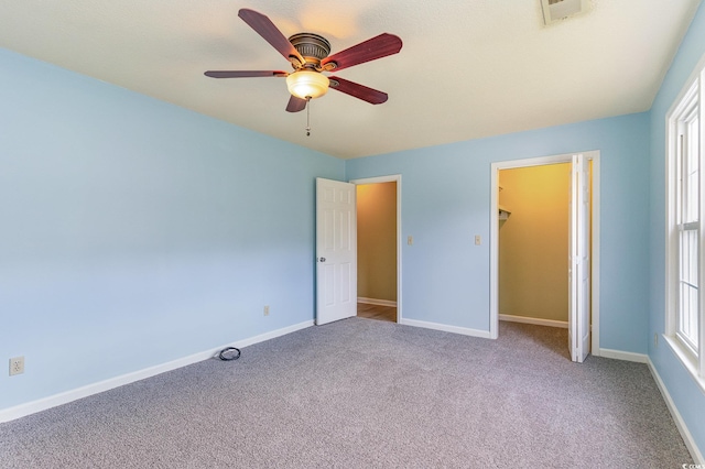 unfurnished bedroom with a closet, carpet flooring, and ceiling fan